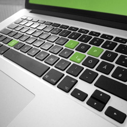 Eine Macbook-Tastatur, auf der das Wort pixl grün hervogehoben ist.